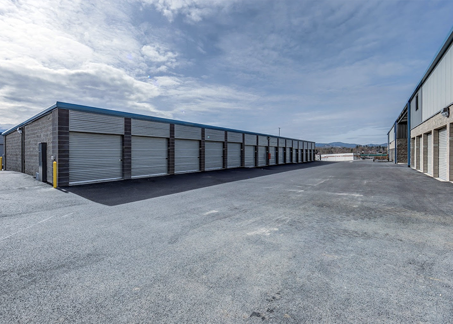 Rows of low storage buildings with metal roll-up doors